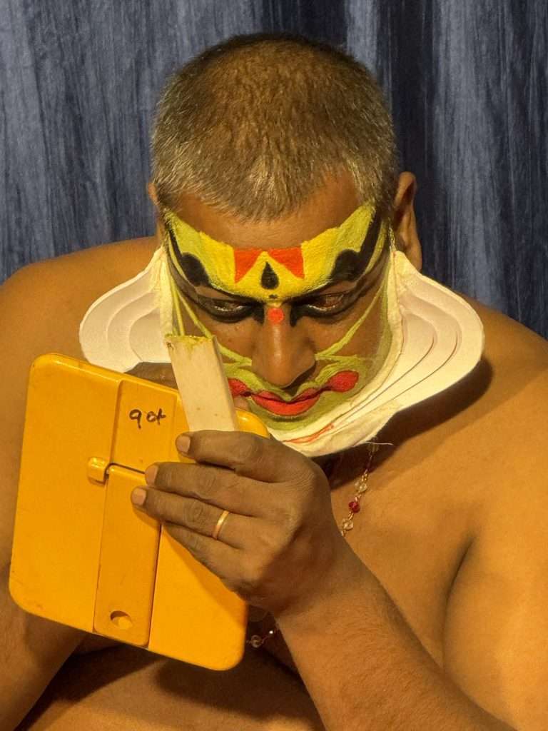 Kerala Kathakali Dancers applying their make up